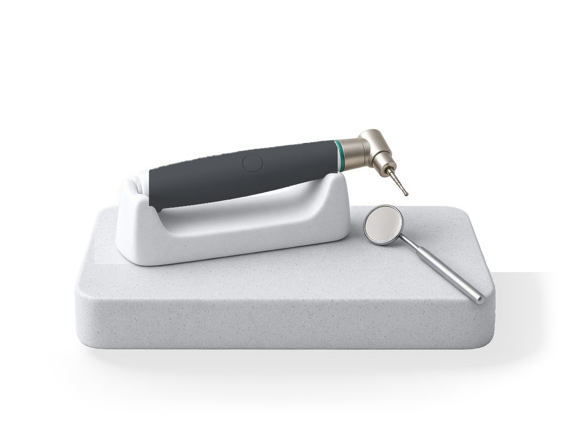 Dental handpiece and examination mirror on a stone plinth